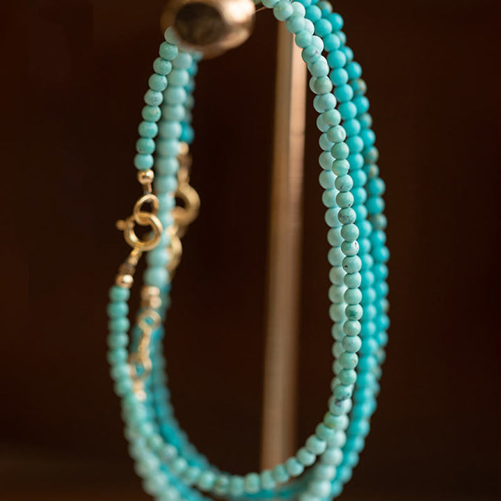 Braccialetto della saggezza in rame placcato oro 14k con perline ultrasottili color turchese da 2 mm Buddha Stones