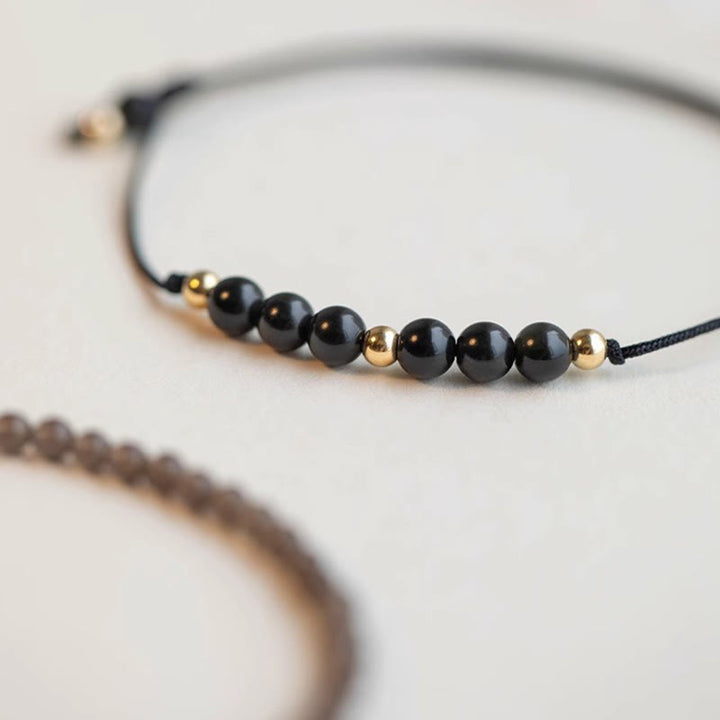 Braccialetto di successo con perline ultrasottili in quarzo fumé e ossidiana nera Buddha Stones