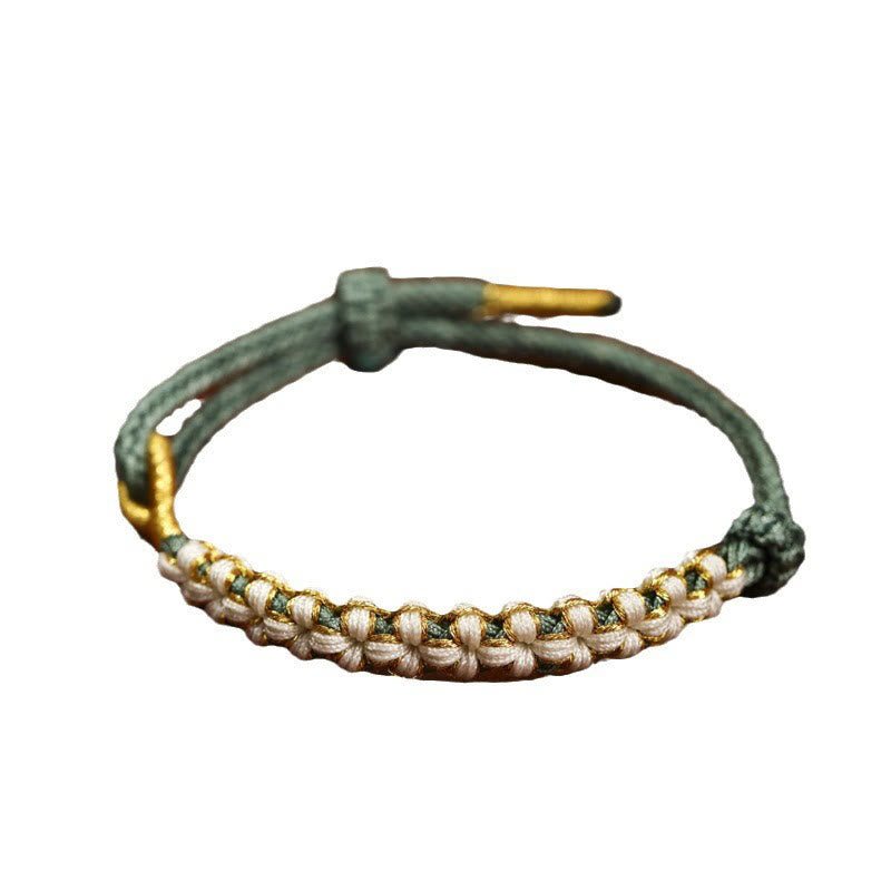 Bracciale intrecciato con nodo di collegamento in fili d'oro tibetani con pietre Buddha Stones e fiori di pesco colorati
