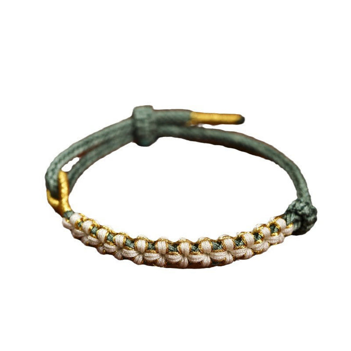 Bracciale intrecciato con nodo di collegamento in fili d'oro tibetani con pietre Buddha Stones e fiori di pesco colorati