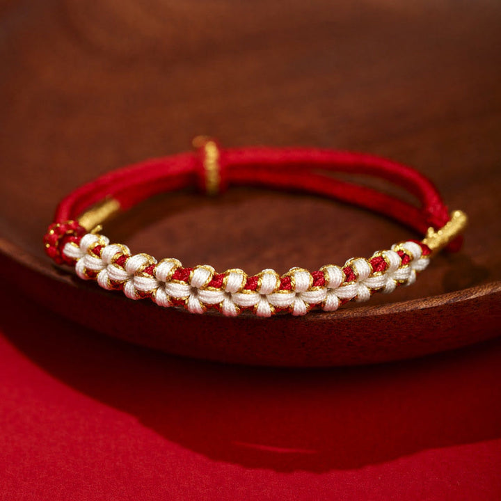 Bracciale intrecciato con nodo di collegamento in fili d'oro tibetani con pietre Buddha Stones e fiori di pesco colorati