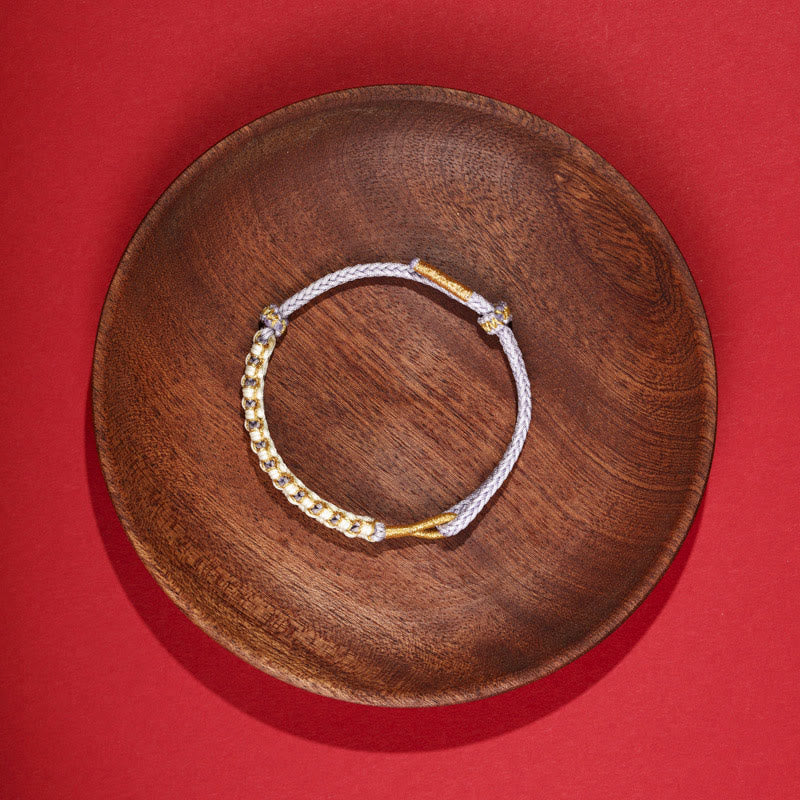 Bracciale intrecciato con nodo di collegamento in fili d'oro tibetani con pietre Buddha Stones e fiori di pesco colorati