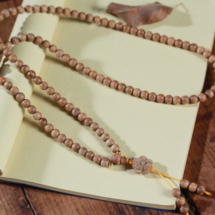 Bracciale Mala di guarigione con ciondolo in legno di sandalo e fiori di prugna Buddha Stones