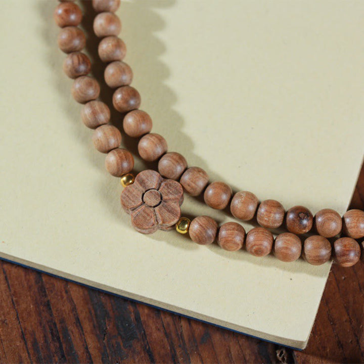 Bracciale Mala di guarigione con ciondolo in legno di sandalo e fiori di prugna Buddha Stones