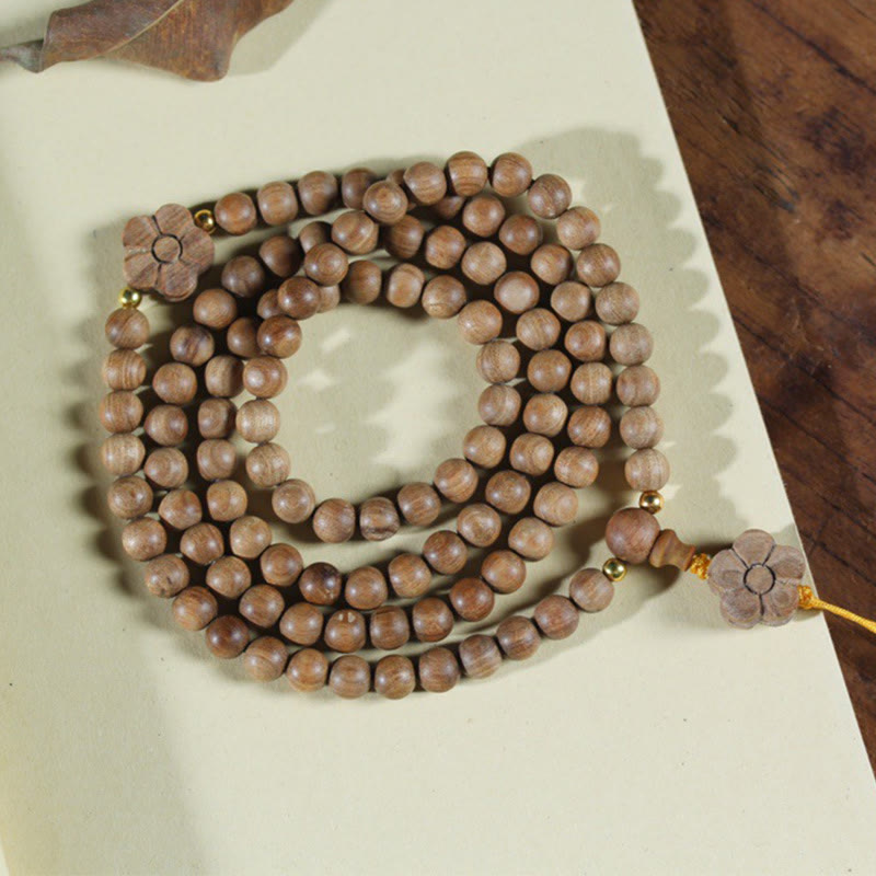 Bracciale Mala di guarigione con ciondolo in legno di sandalo e fiori di prugna Buddha Stones