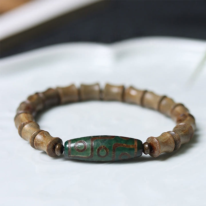 Braccialetto della pace in legno di sandalo verde con perline Dzi tibetane a nove occhi Buddha Stones