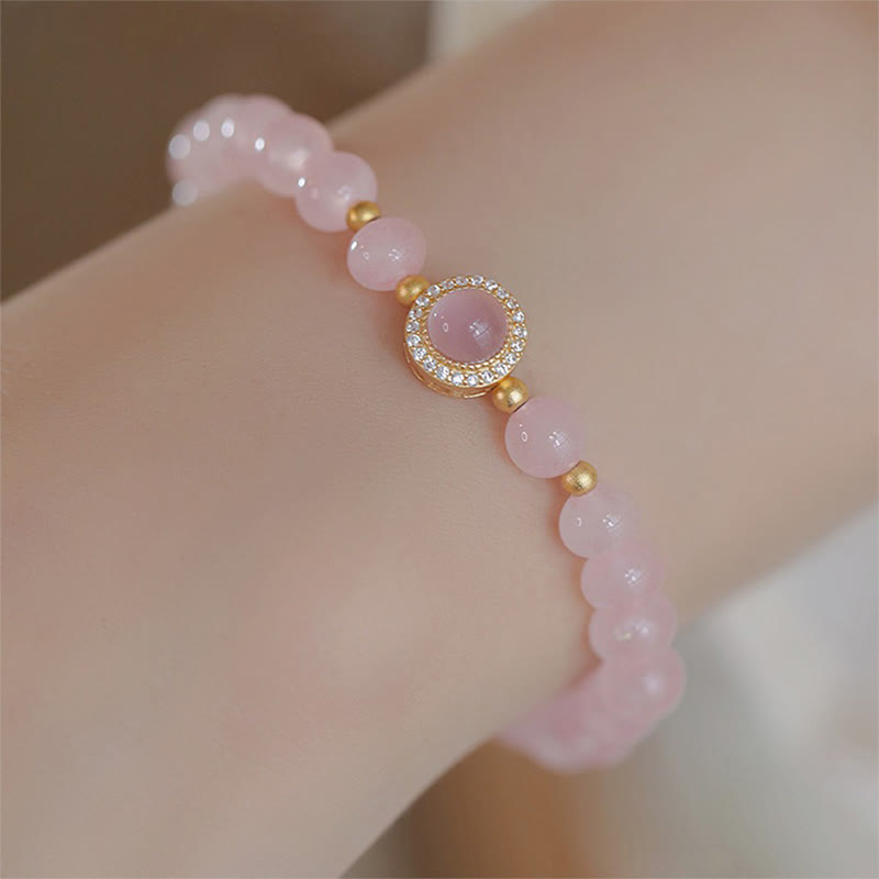Braccialetto Buddha Stones con perle di cristallo rosa e calore