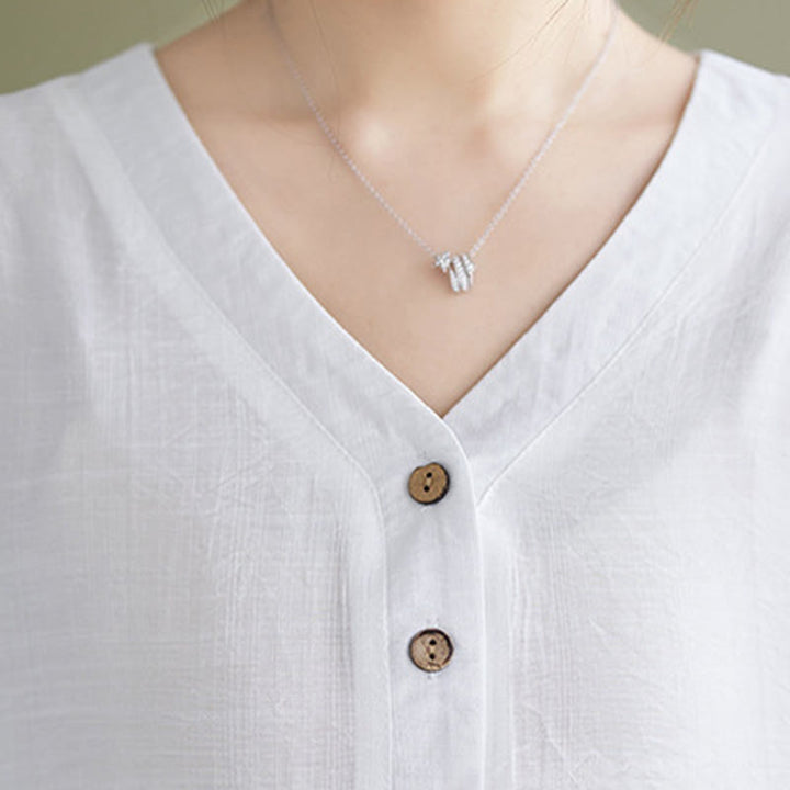 Camicia in viscosa a mezza manica con scollo a V e design casual semplice da donna Buddha Stones