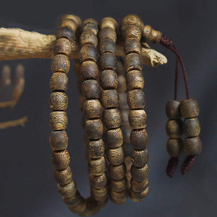 Buddha Stones 108 perline Mala da 6 mm con perline cilindriche Hainan Verde Qinan Bracciale calmo in legno di agar