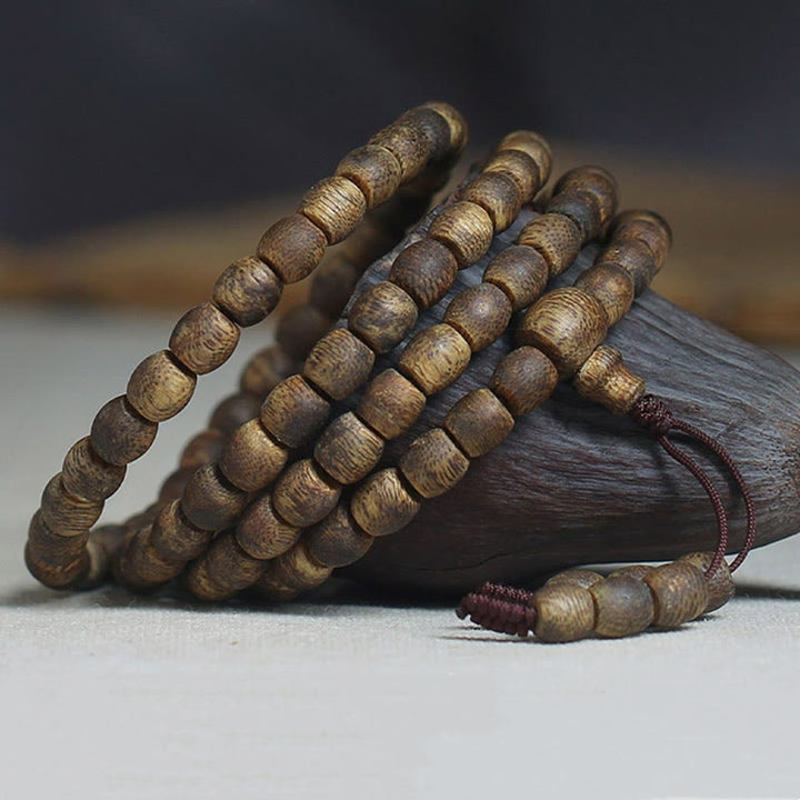 Buddha Stones 108 perline Mala da 6 mm con perline cilindriche Hainan Verde Qinan Bracciale calmo in legno di agar