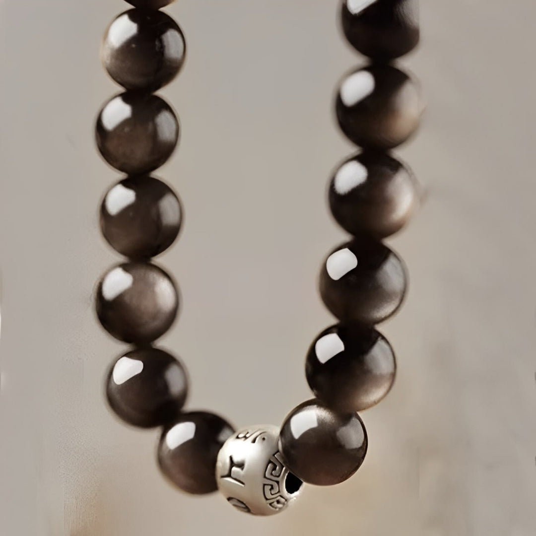 Bracciale di protezione Om Mani Padme Hum in ossidiana naturale lucida e argento Buddha Stones