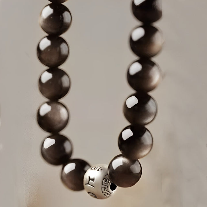Bracciale di protezione Om Mani Padme Hum in ossidiana naturale lucida e argento Buddha Stones