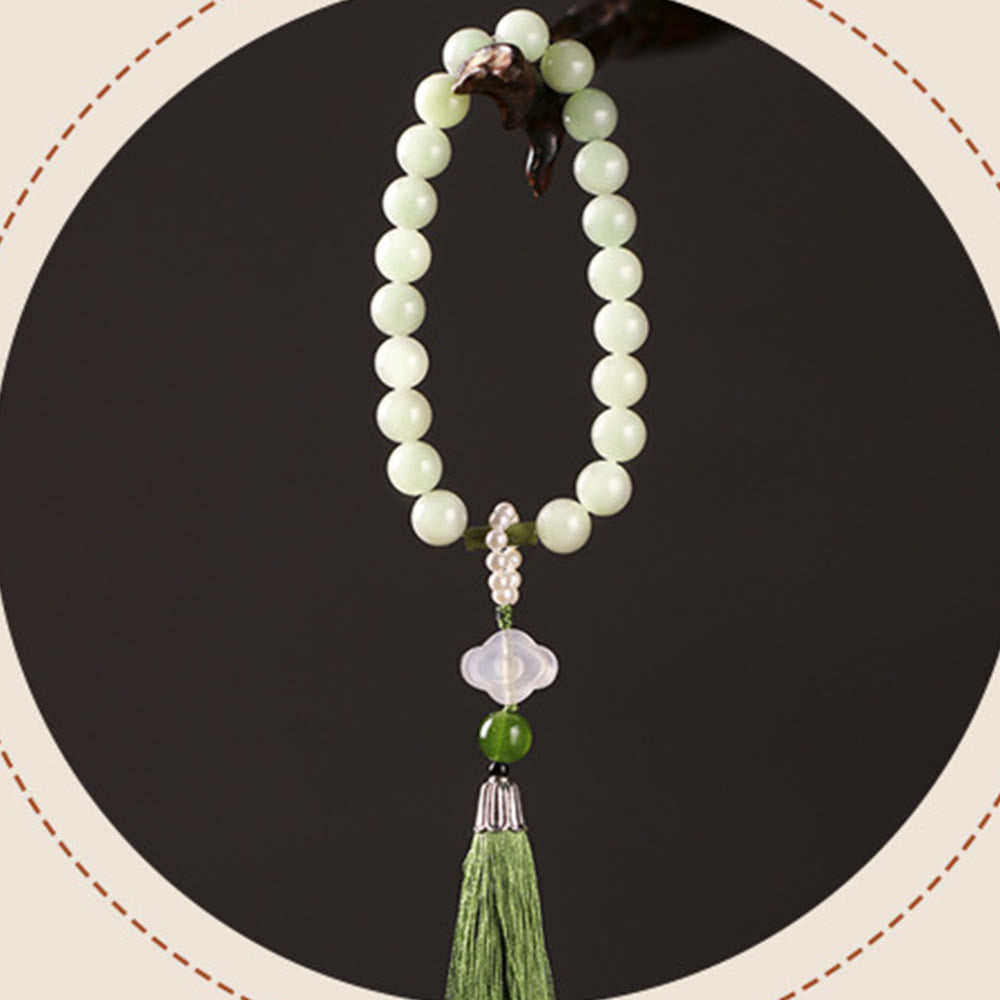 Mala da polso Buddha Stones, perle di giada verde e nappe di prosperità.