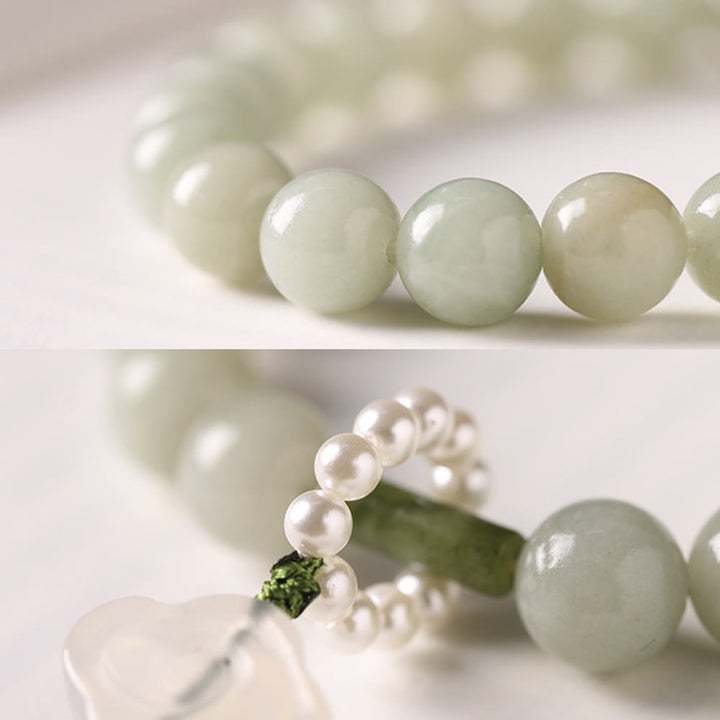 Mala da polso Buddha Stones, perle di giada verde e nappe di prosperità.
