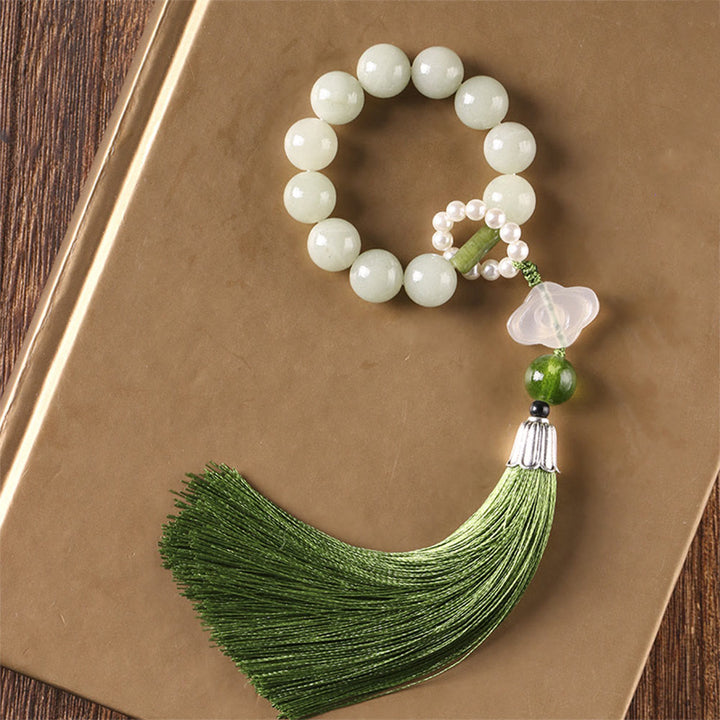 Mala da polso Buddha Stones, perle di giada verde e nappe di prosperità.