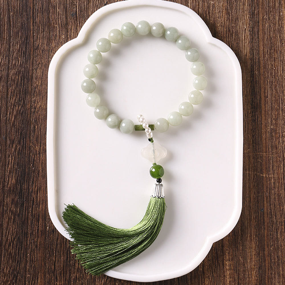 Mala da polso Buddha Stones, perle di giada verde e nappe di prosperità.