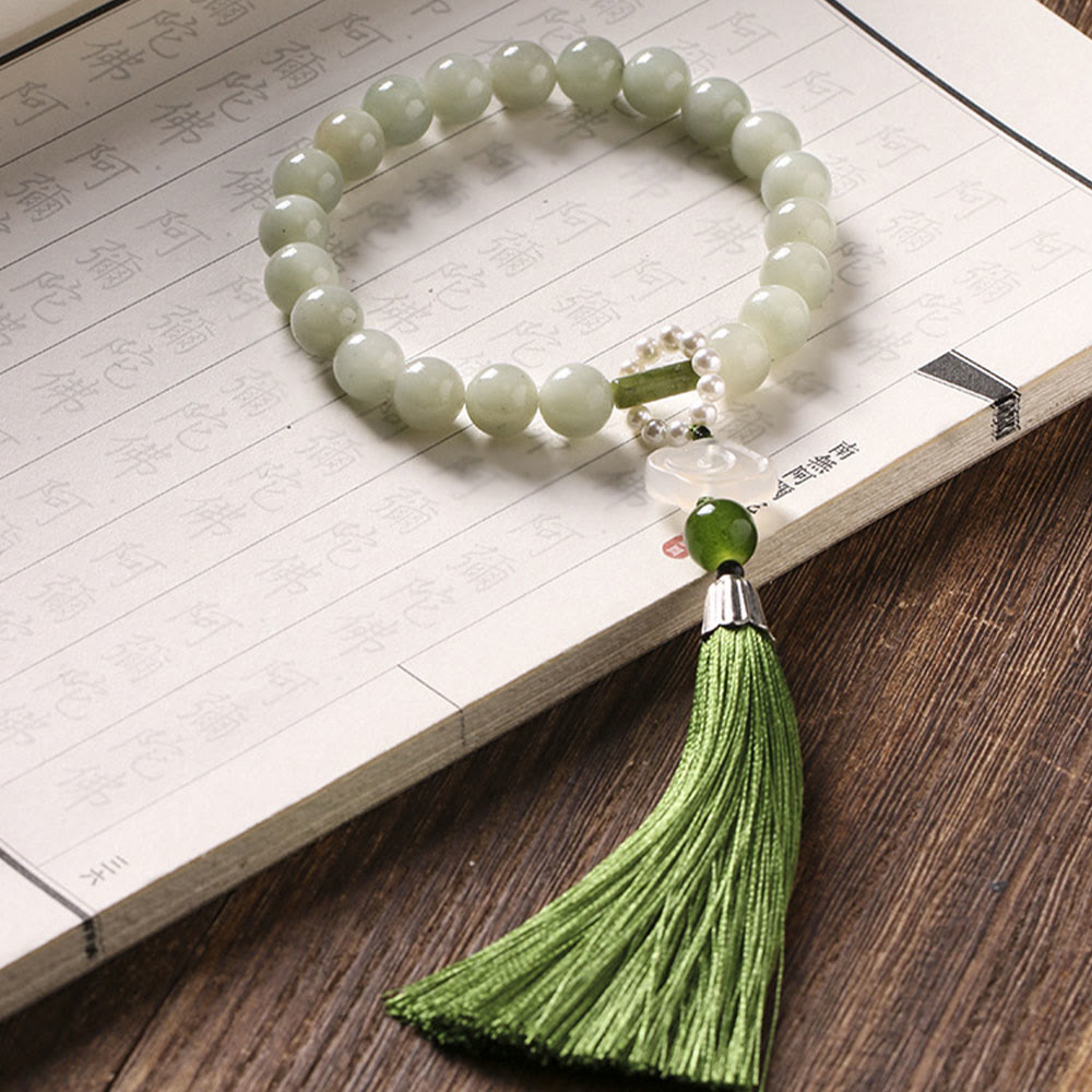 Mala da polso Buddha Stones, perle di giada verde e nappe di prosperità.