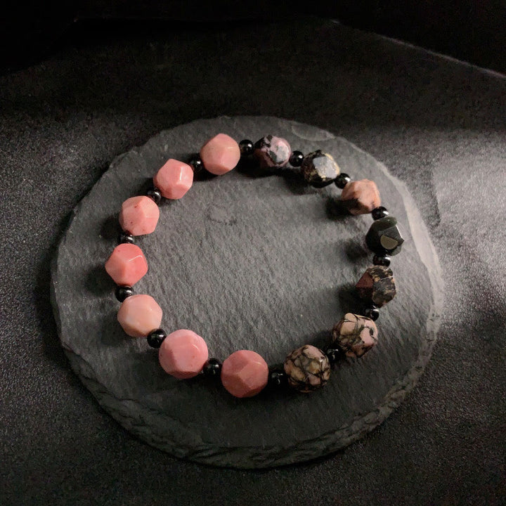 Braccialetto curativo con perline poligonali in pietra di rodonite naturale con linea nera e macchie rosse Buddha Stones
