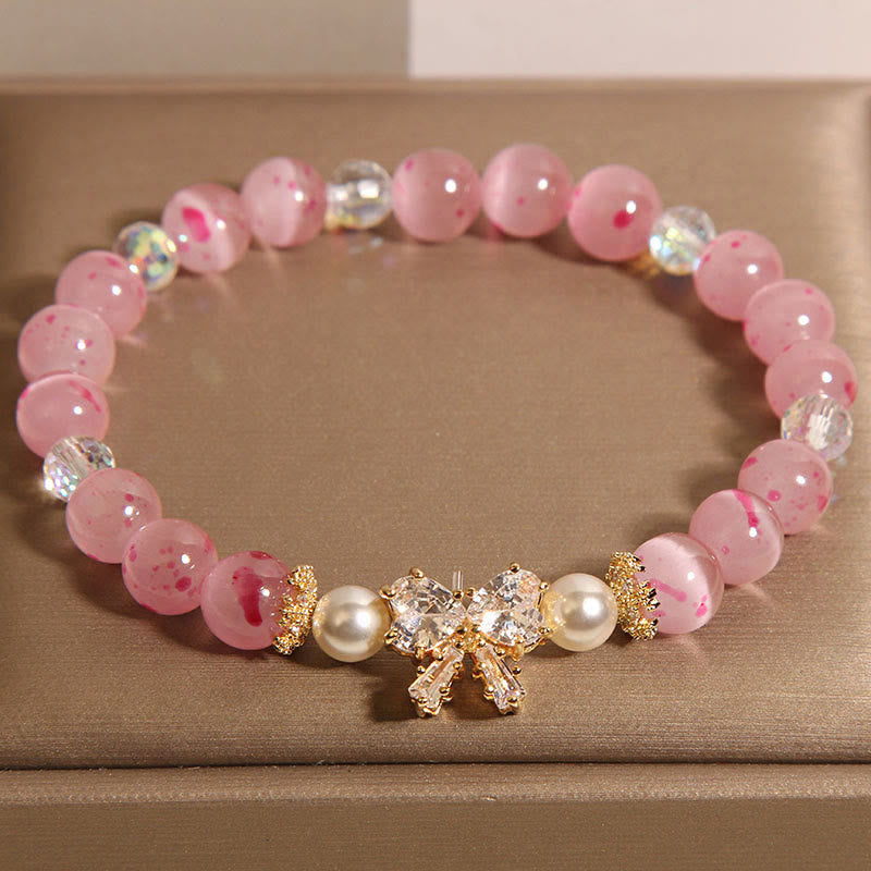 Braccialetto di supporto con fiocco e rosetta, in perle occhio di gatto rosa e fiori di ciliegio Buddha Stones