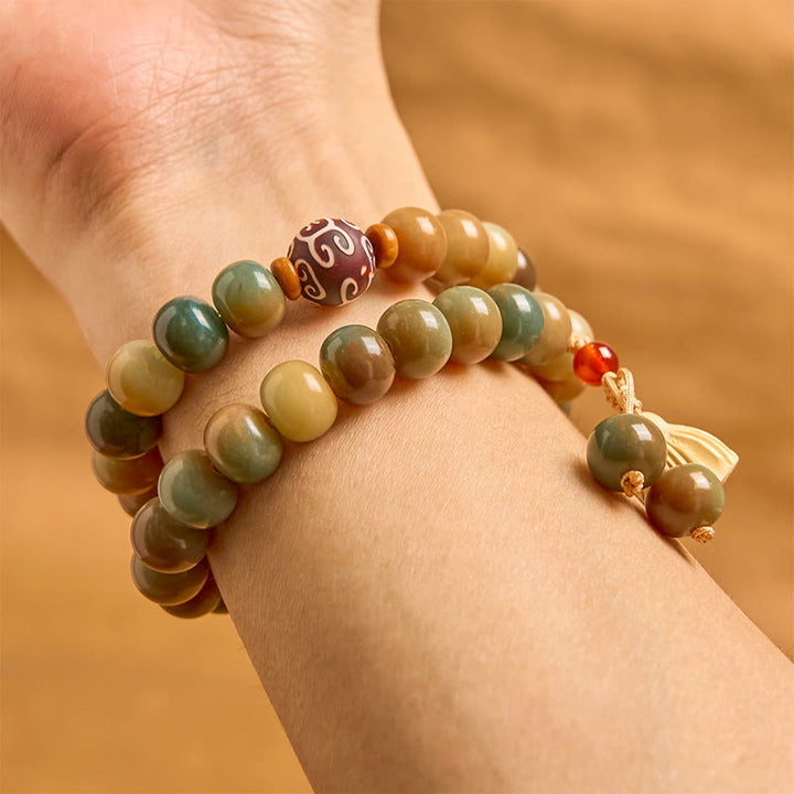 Bracciale doppio giro con ciondolo a forma di baccello di loto con semi di Bodhi colorati Buddha Stones