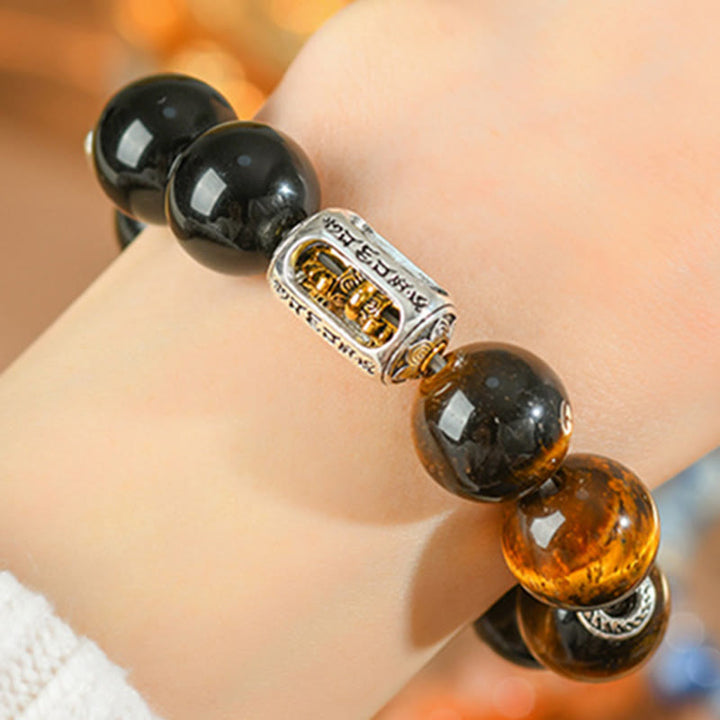 Bracciale di protezione Vajra in ossidiana naturale con occhio di tigre e argento lucido Buddha Stones