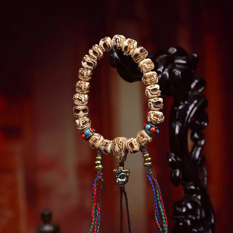 Braccialetto di protezione con nappa intagliata in osso di cammello Buddha Stones e Garuda