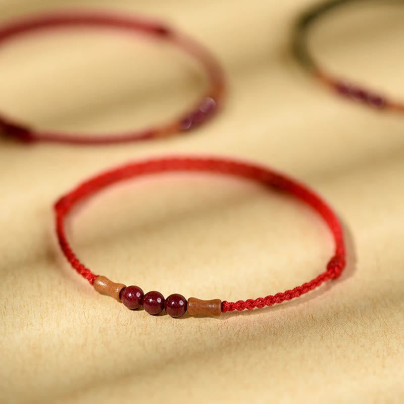 Braccialetto di benedizione con perle di cinabro e Buddha Stones in legno di pesca