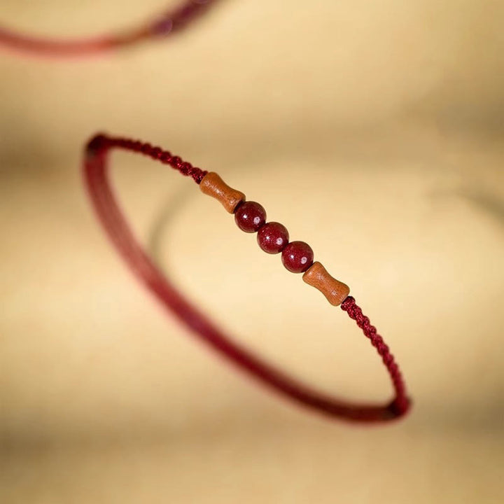 Braccialetto di benedizione con perle di cinabro e Buddha Stones in legno di pesca