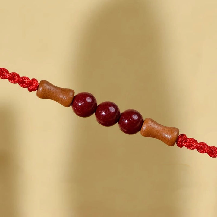 Braccialetto di benedizione con perle di cinabro e Buddha Stones in legno di pesca