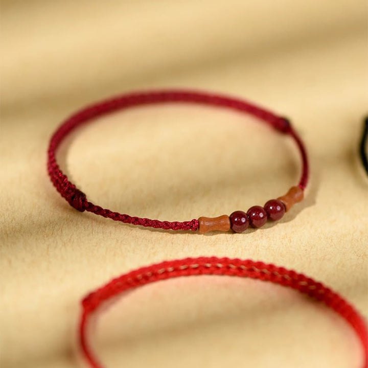 Braccialetto di benedizione con perle di cinabro e Buddha Stones in legno di pesca