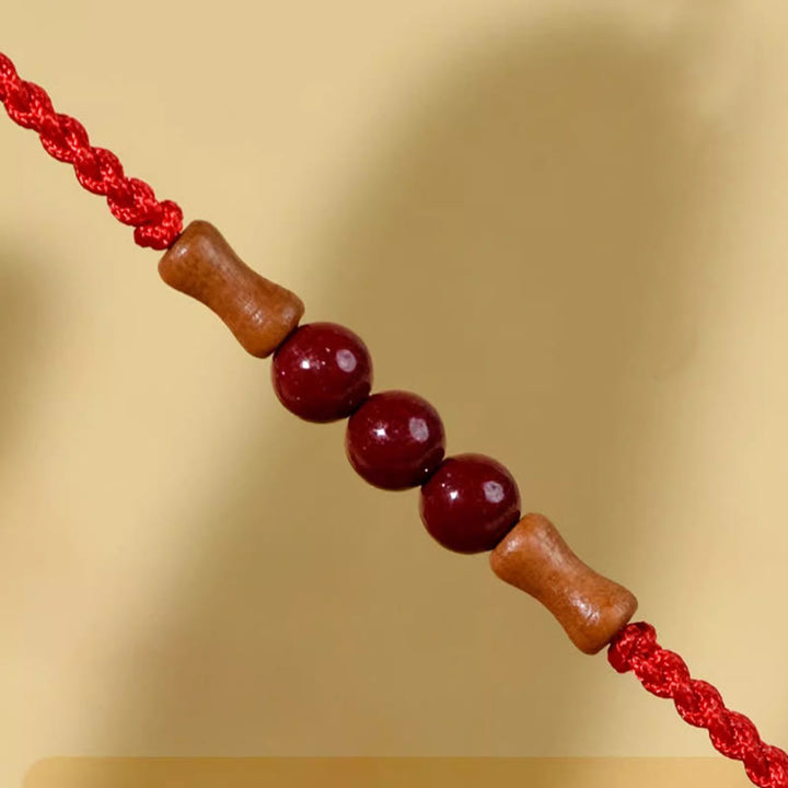 Braccialetto di benedizione con perle di cinabro e Buddha Stones in legno di pesca