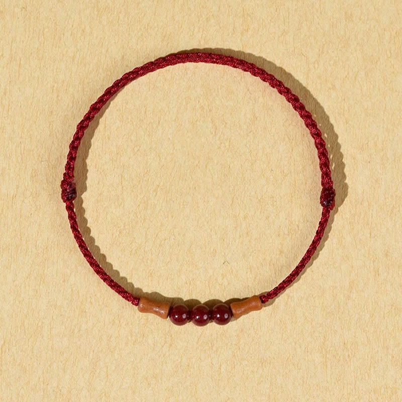 Braccialetto di benedizione con perle di cinabro e Buddha Stones in legno di pesca