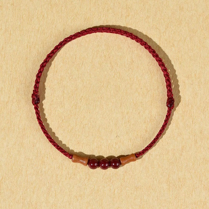 Braccialetto di benedizione con perle di cinabro e Buddha Stones in legno di pesca