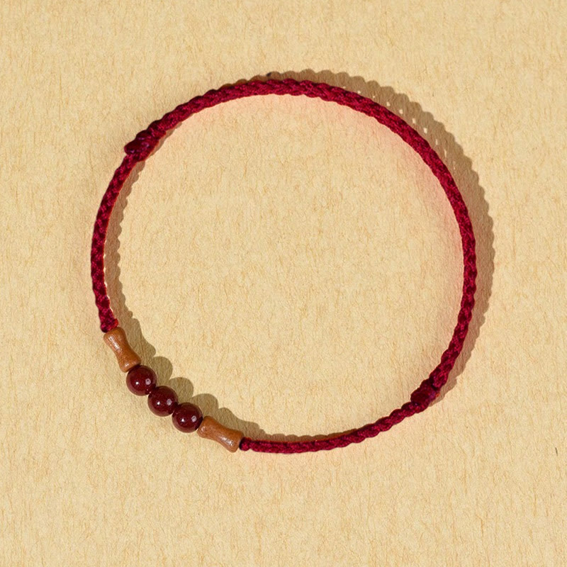 Braccialetto di benedizione con perle di cinabro e Buddha Stones in legno di pesca