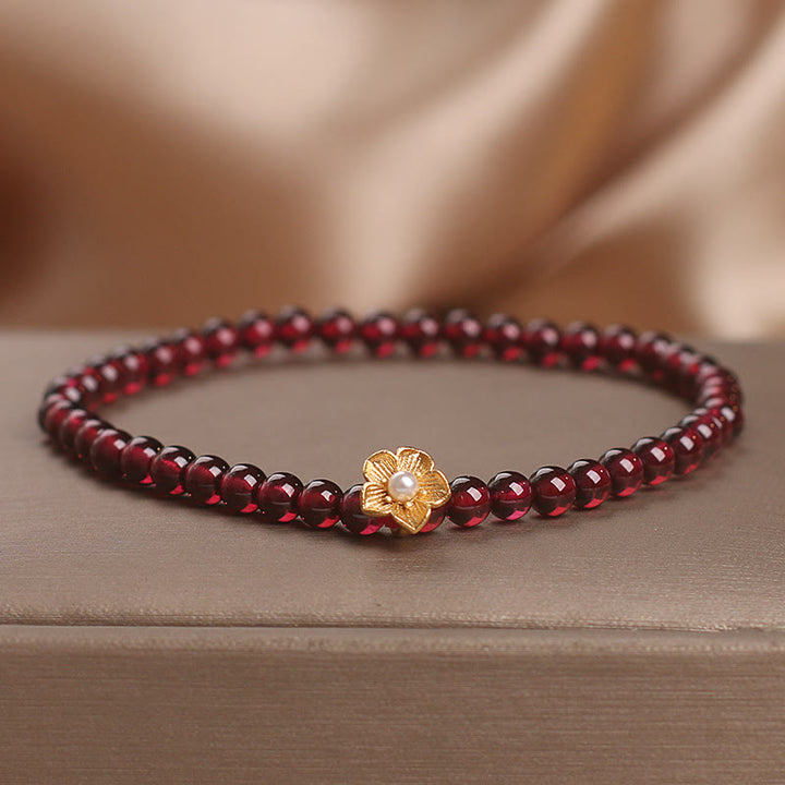 Bracciale Buddha Stones con perle di granato naturale da 4 mm e fiore della passione