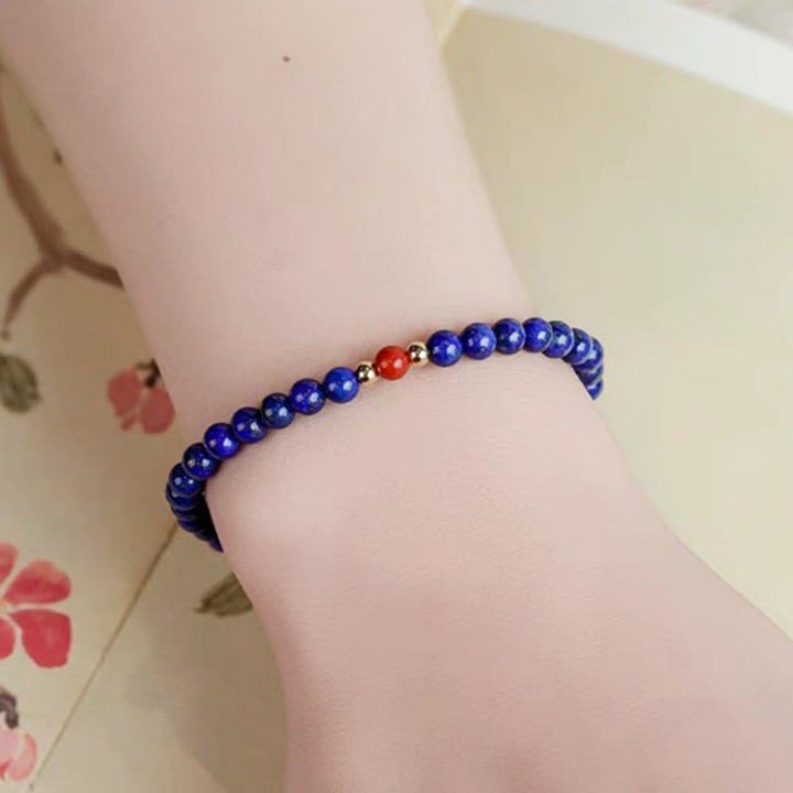 Braccialetto positivo con perle ultrasottili di cinabro e piccole Buddha Stones
