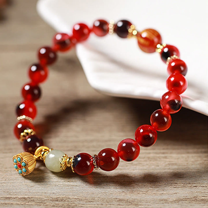 Braccialetto curativo con baccello di loto dorato in agata caramellata naturale colorata Buddha Stones - image 18
