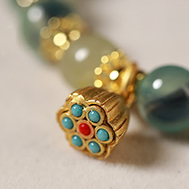 Braccialetto curativo con baccello di loto dorato in agata caramellata naturale colorata Buddha Stones - image 8