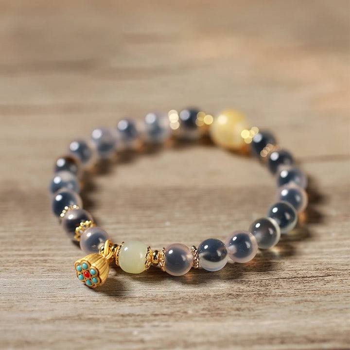 Braccialetto curativo con baccello di loto dorato in agata caramellata naturale colorata Buddha Stones - image 13