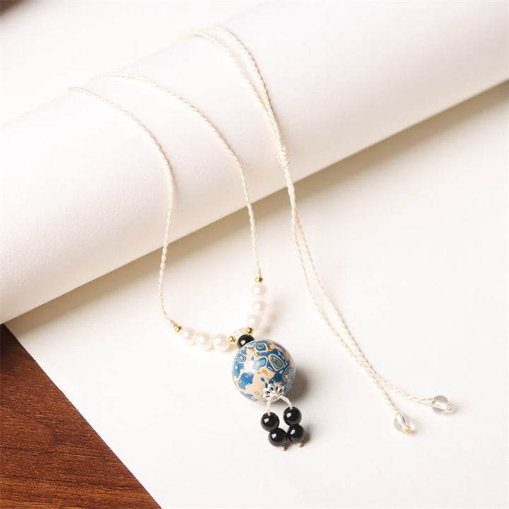 Collana con Buddha Stones, ebano, lacca Aurora, perline artigianali, perle, equilibrio - Ciondolo blu bianco (blu bianco casuale) - image 11