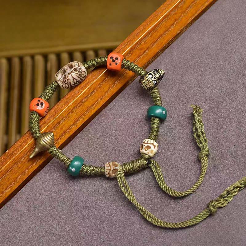 Braccialetto di corda fatto a mano con dadi e motivo drago tibetano di Buddha Stones - image 1