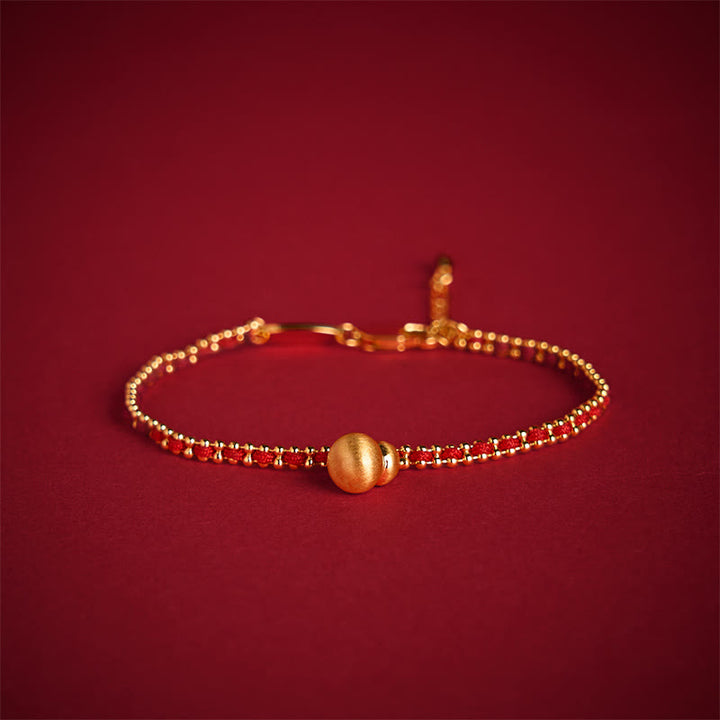 Bracciale Buddha Stones in corda rossa, rame e ottone, zucca, forza e ricchezza - image 1