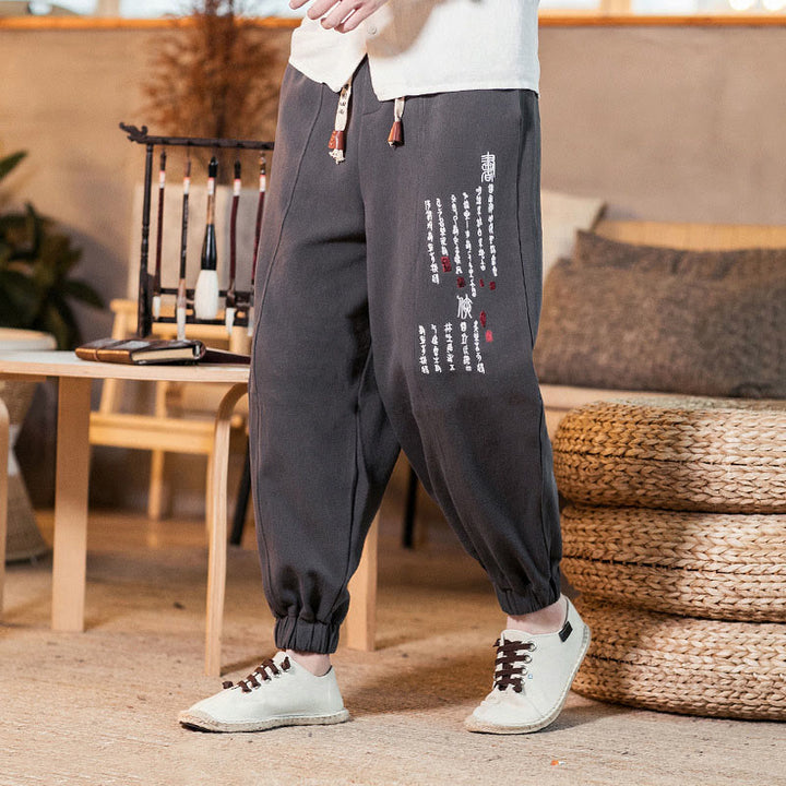 Pantaloni da uomo in cotone con tasche e motivo a caratteri cinesi ricamati con Buddha Stones - image 1
