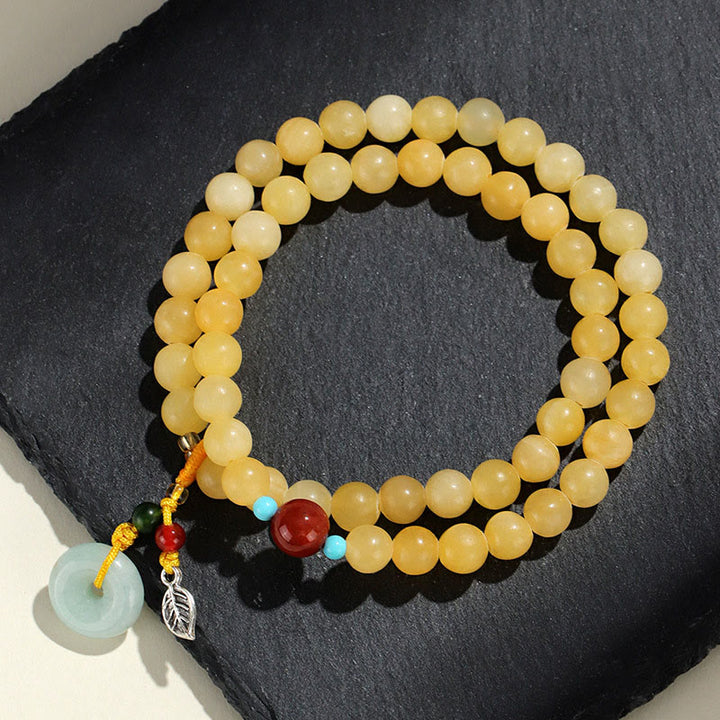 Bracciale della ricchezza con fibbia della pace a doppio giro in Buddha Stones e topazio - image 1
