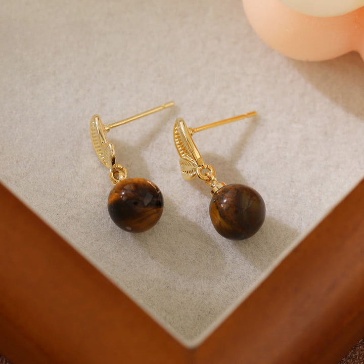 Buddha Stones Orecchini di protezione in rame con design a foglie occhio di tigre - image 2