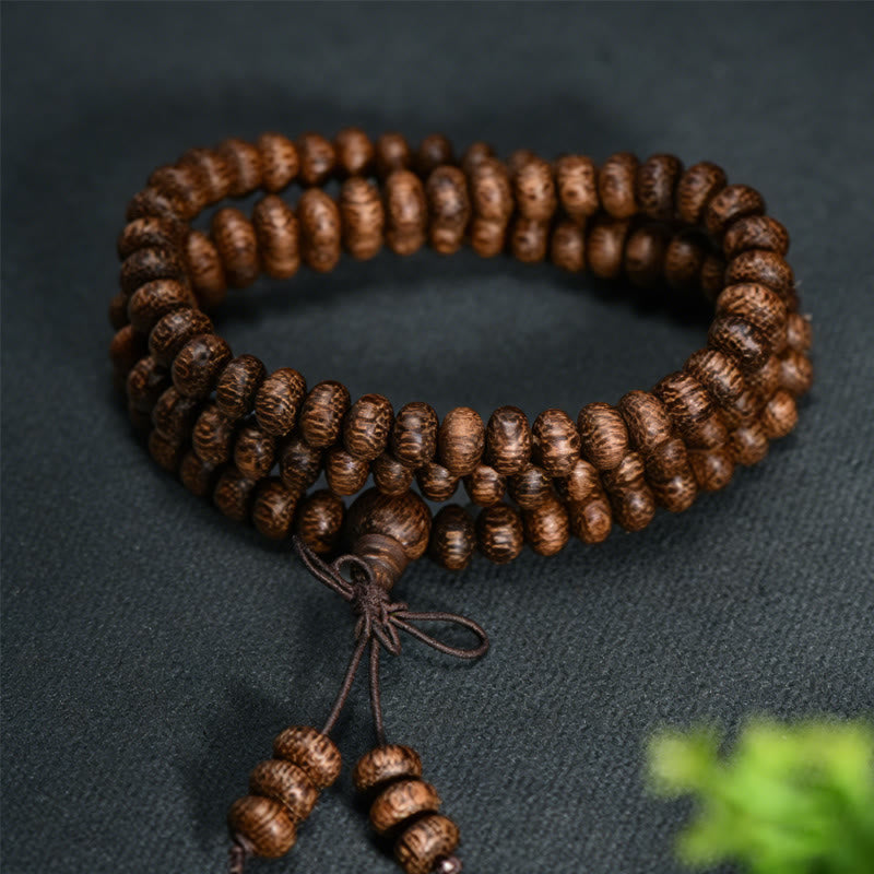 Buddha Stones Mala con 108 perline di legno testurizzate per un'energia calmante - image 1
