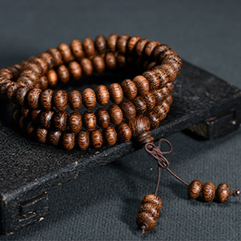 Buddha Stones Mala con 108 perline di legno testurizzate per un'energia calmante - 6*9mm*108 - image 0