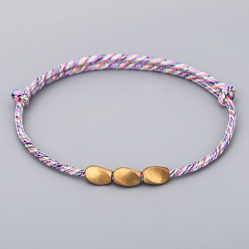 Buddha Stones Bracciale con perline di rame dorato e filo multicolore. - Rosa chiaro - image 0