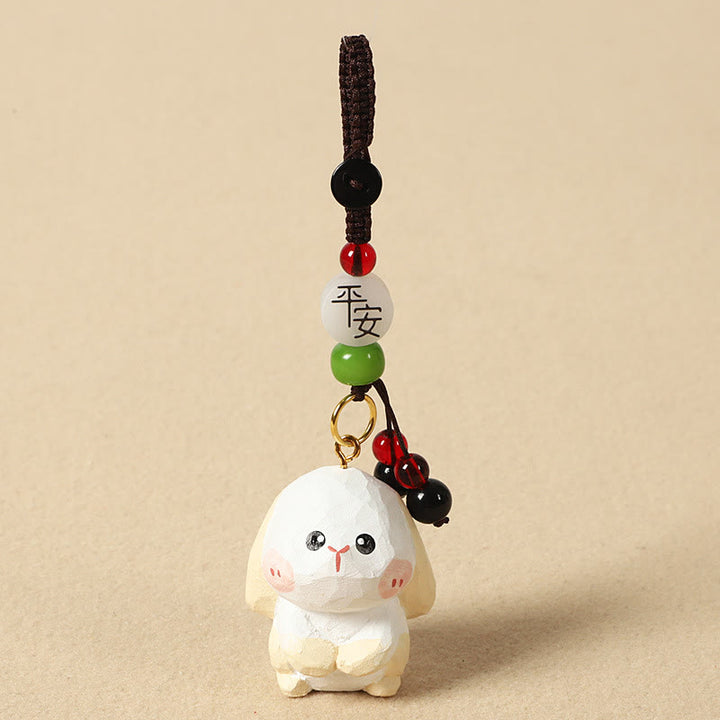 Buddha Stones Portachiavi in ​​legno di tiglio inciso con zodiaco cinese, fiore di pruno, pace e sicurezza, Om Mani Padme Hum, simbolo positivo. - Coniglio di 4 cm (colore, forma e dimensioni possono variare) - Pace e sicurezza - image 18