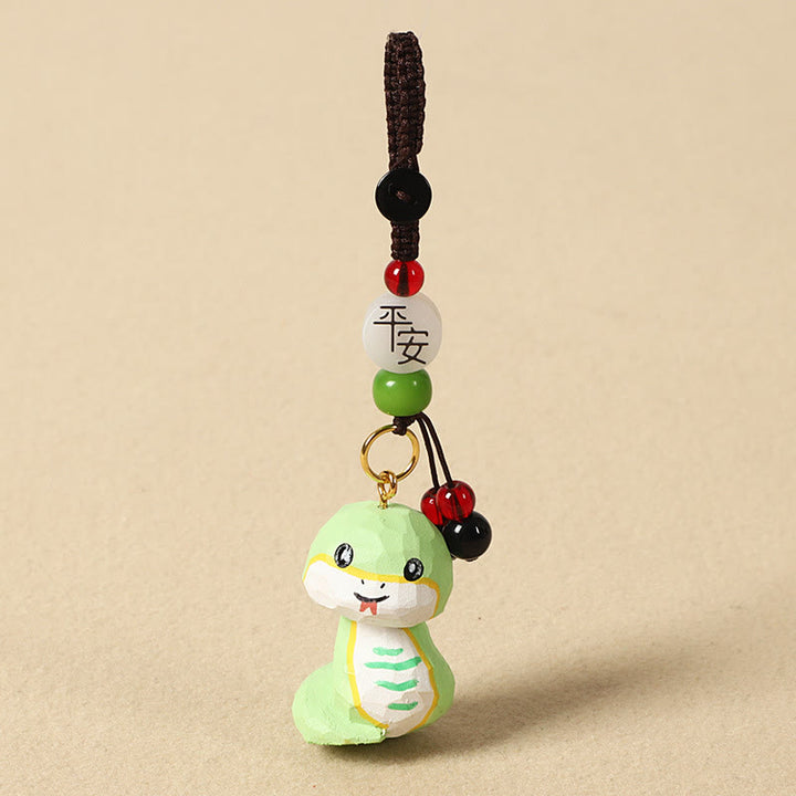 Buddha Stones Portachiavi in ​​legno di tiglio inciso con zodiaco cinese, fiore di pruno, pace e sicurezza, Om Mani Padme Hum, simbolo positivo. - Serpente di 4 cm (colore, forma e dimensioni possono variare) - Pace e sicurezza - image 25